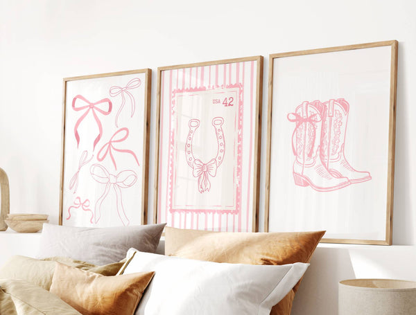 Bedroom with framed pink line art on the wall, featuring a bow, horseshoe, and boots.