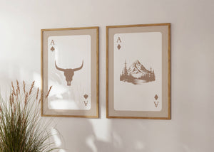 set of 2 playing card wall art with longhorn bull skull and mountain in beige