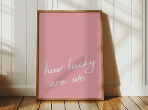 pink print with white typography how lucky are we quote