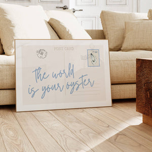 the world is your oyster in blue script typography on horizontal postcard print with oyster postal stamp