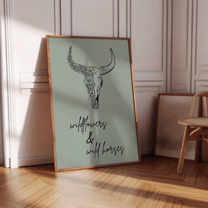 wildflowers and wild horses print in sage green with black typography and cow skull with flowers poster