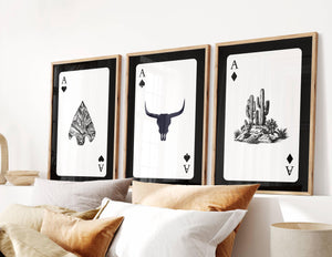set of 3 western playing card wall art in black and white with longhorn skull and desert cactus scene