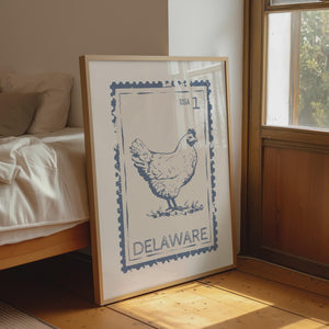 delaware state stamp print in dusty blue with blue hen graphic, vertical orientation travel wall art