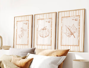 set of 3 orange fall wall art with acorn branch, pumpkin and maple leaf on retro stamp poster with vintage stripe